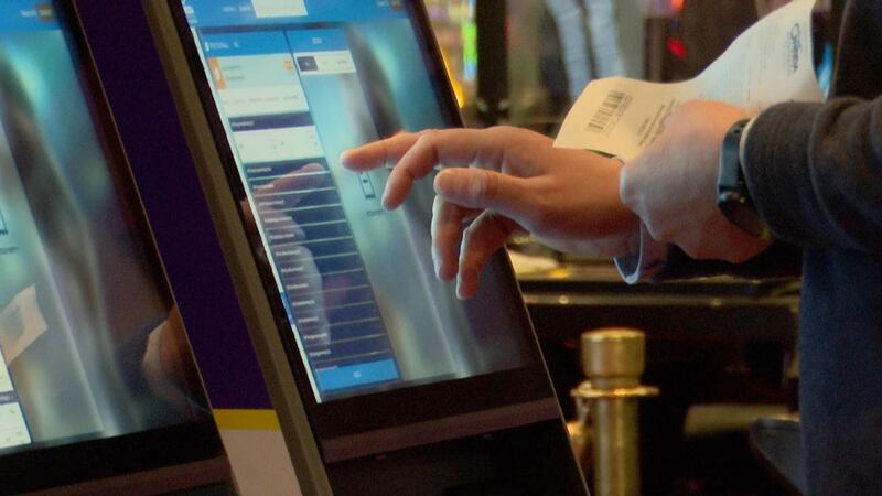 Customer using sports betting kiosk at Oneida Casino.