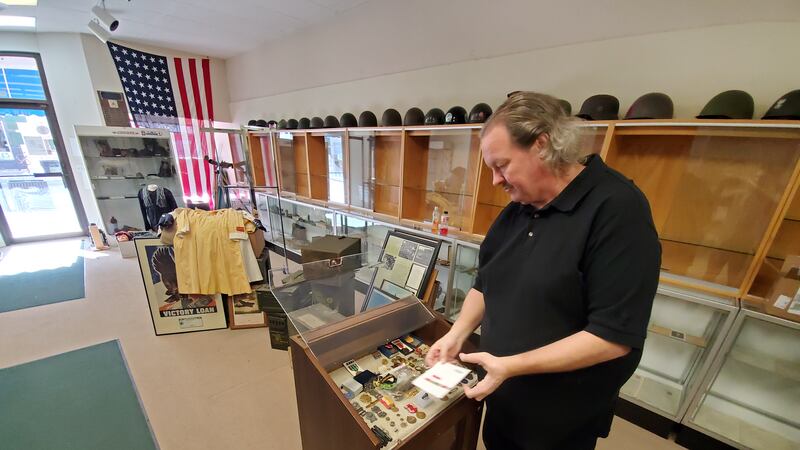 Bret Esse packs up some military medals that are a part of his massive WWII collection