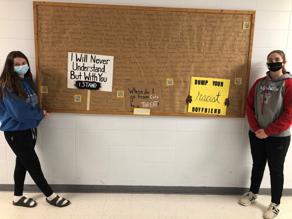 Lauren Bird (right) and Skylar Linde (left) pose in front of Linde's piece after the two had...