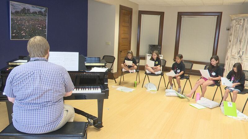 Theatre students aged 7-9 years old are being taught how to sing and act during theatre camp