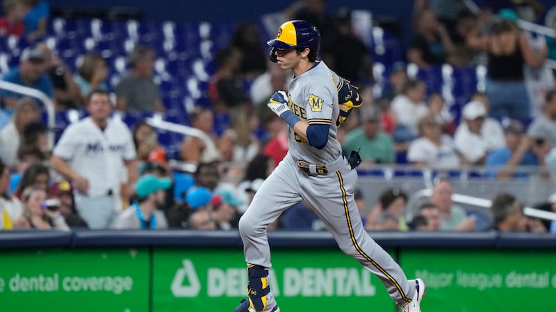 Milwaukee Brewers' Christian Yelich rounds third base as he heads home after hitting a home...