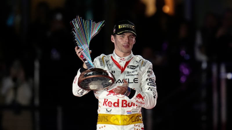 Red Bull driver Max Verstappen, of the Netherlands, holds a trophy after winning the Formula...