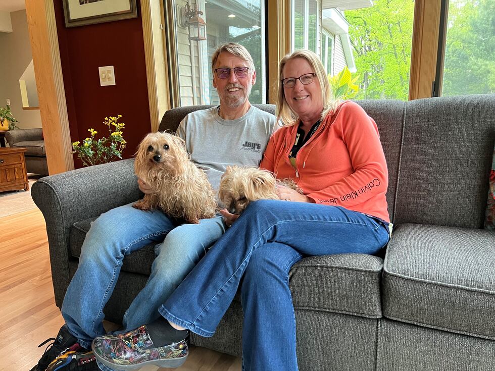 Ian and Deb Judd hang out in their home in Juneau County with their dogs Lacy and Brody
