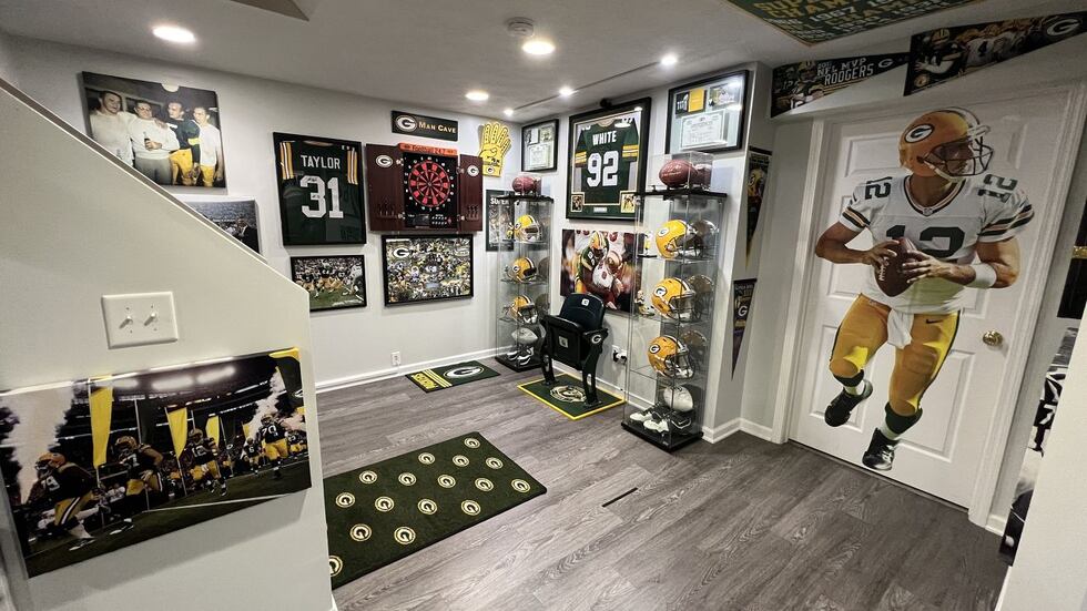 Two of Lomeli's prized possessions: a signed Reggie White jersey and a seat from Lambeau Field