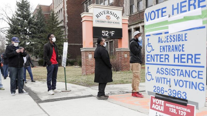 Voters line up at Riverside High School for Wisconsin's primary election Tuesday April 7,...