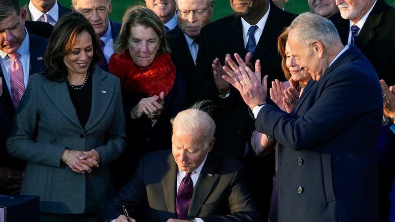 FILE - President Joe Biden signs the $1.2 trillion bipartisan infrastructure bill into law...