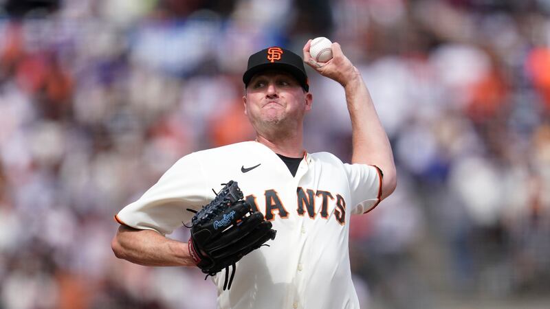 San Francisco Giants' Jake McGee pitches against the Los Angeles Dodgers during the ninth...