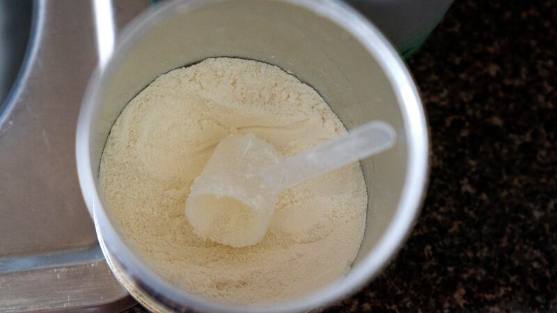 FILE - Only a few scoops are left in a mother's next to last can of baby formula in Laurel,...