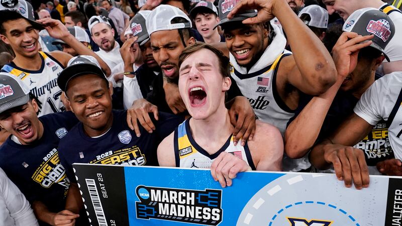 Marquette's Tyler Kolek, tournament MVP, center, celebrates with his teammates after winning...