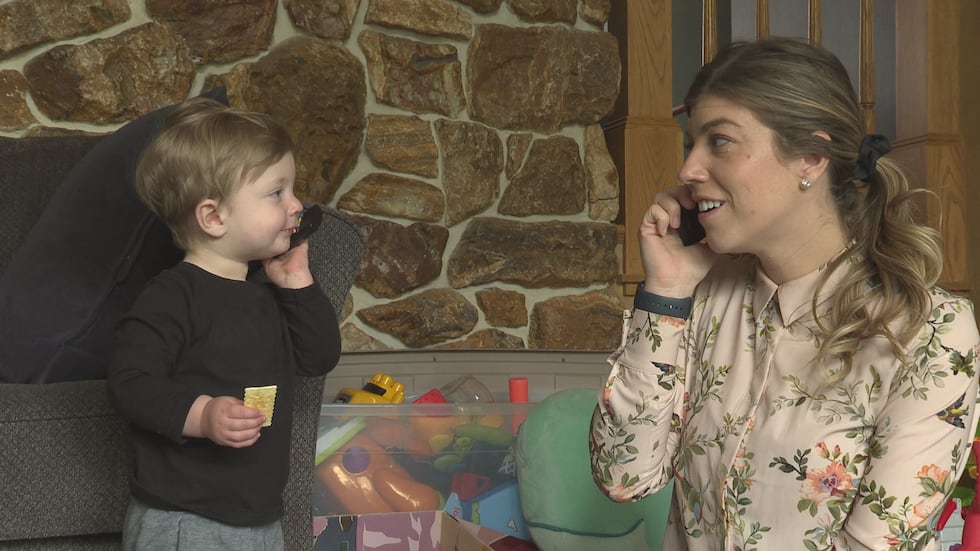 Molly Adzic pretends to talk on the phone with her son. She worked several months without...