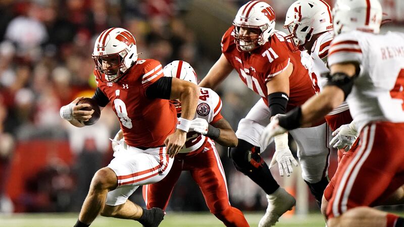 Wisconsin's Tanner Mordecai (8) runs during the first half of an NCAA college football game...